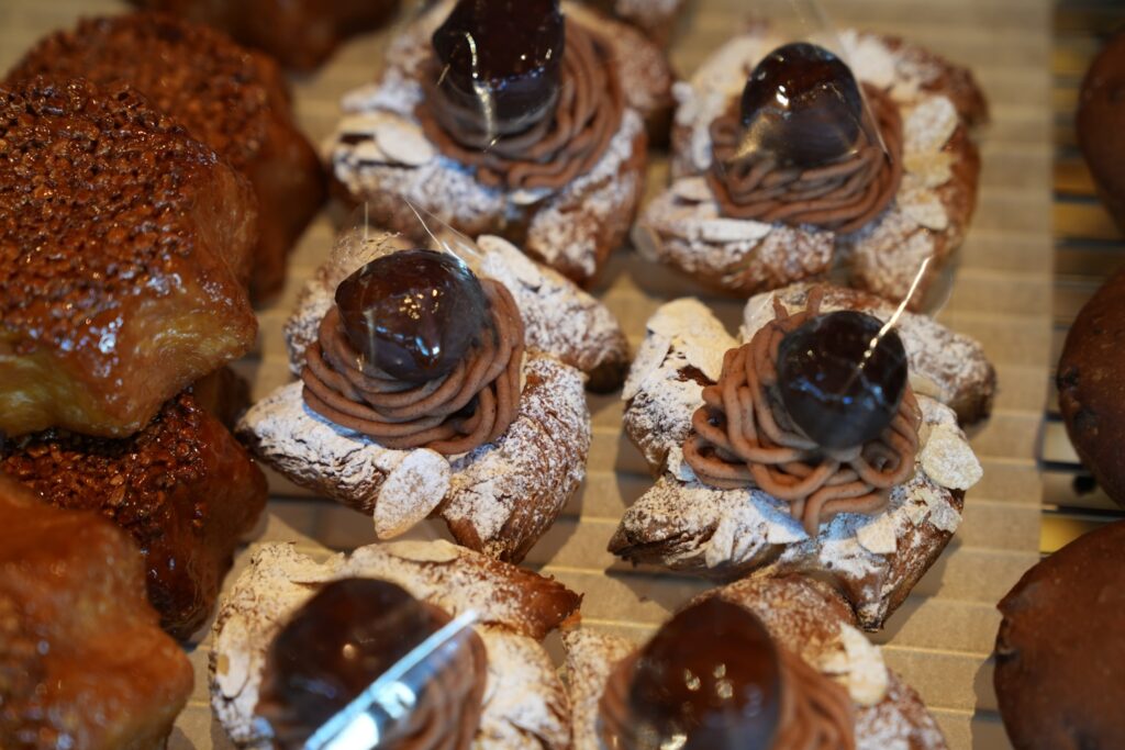 Sweet pastries topped with chocolate and powdered sugar
