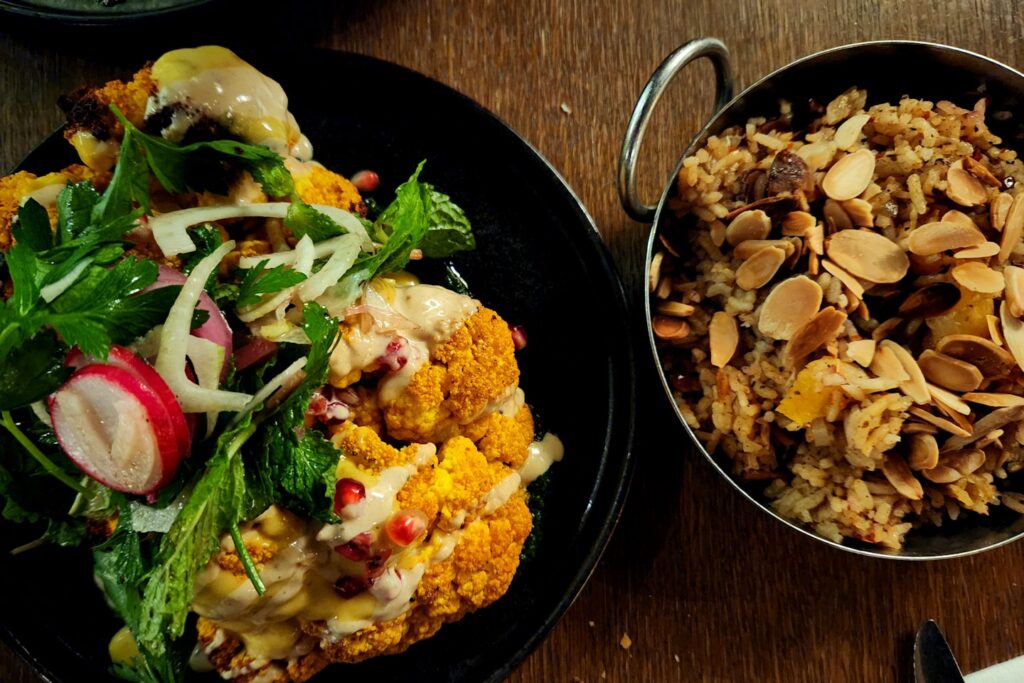 two plates of food on a wooden table